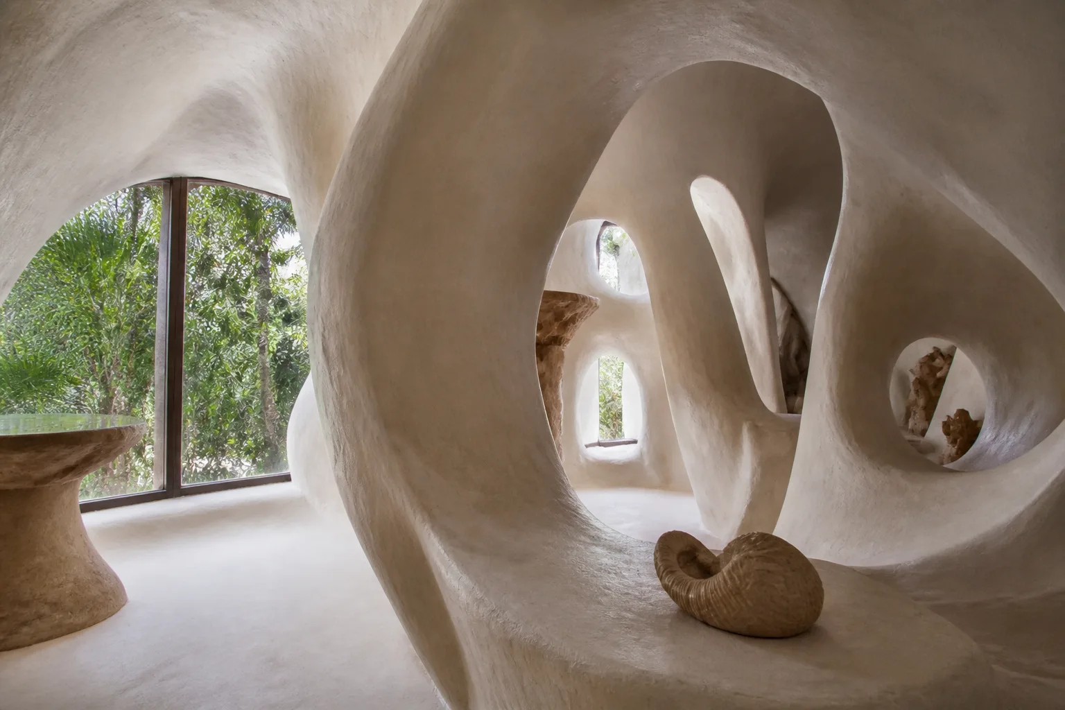 Tropical vegetation seen through flowing organic architecture in Tulum
