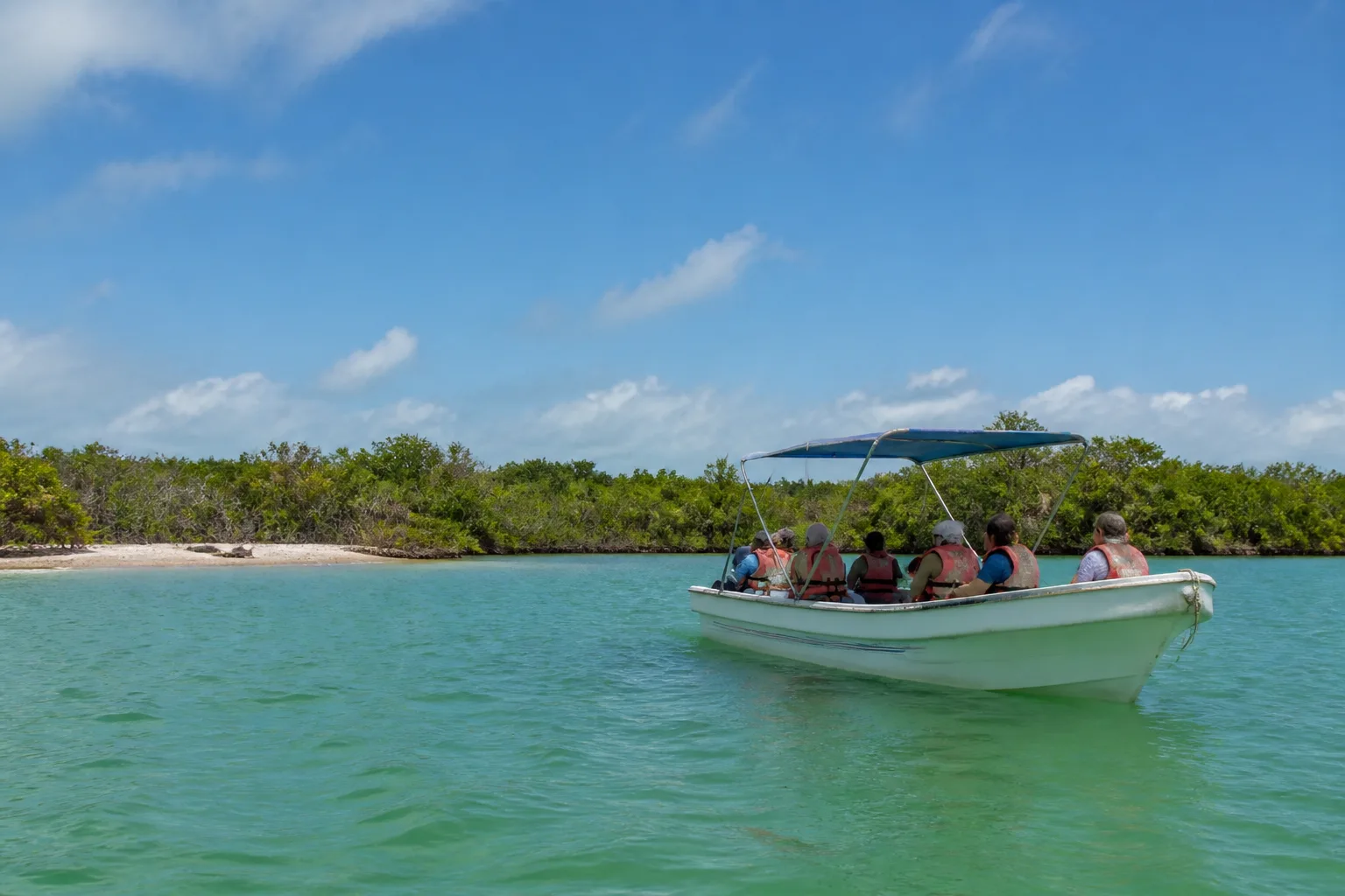 Small passenger boat on protected coastal water near Tulum