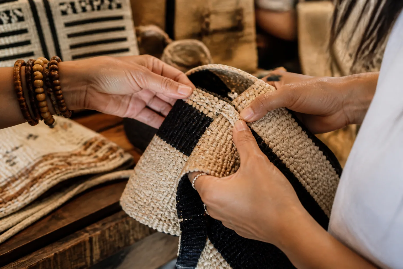 Shopper examining the materials and workmanship of a woven craft